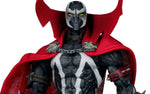 A detailed action figure of Spawn from the DC Comics universe, featuring his signature black and white skull-patterned mask, bright red cape, and metallic silver and black armor with chains and skull accessories, set against a plain white background.